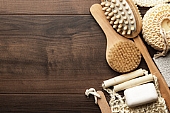 some bath accessories on the brown wooden background